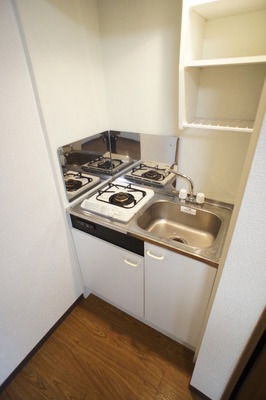 Kitchen. Gas stove is located 1-neck