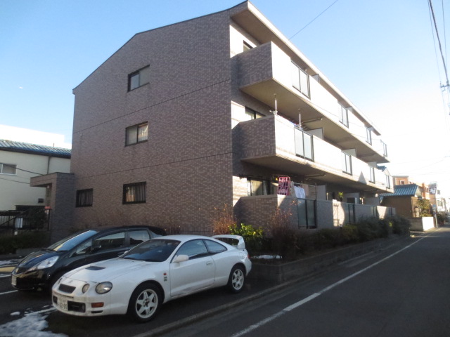 Building appearance. Before the property is a parking lot. 