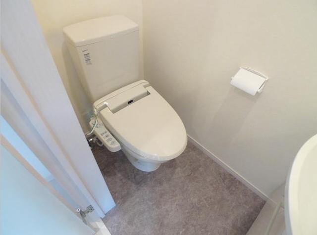 Toilet. Same construction company indoor image is a photo. 