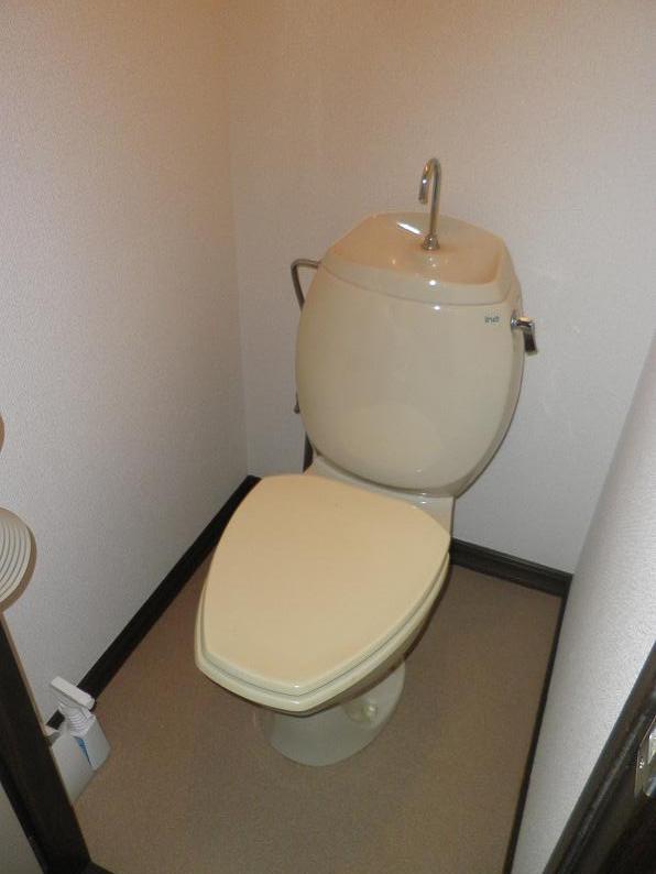 Toilet. Toilet with paper holder