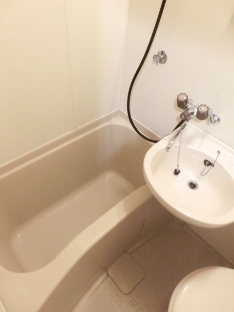 Bath. It is a bath with a wash basin and mirror