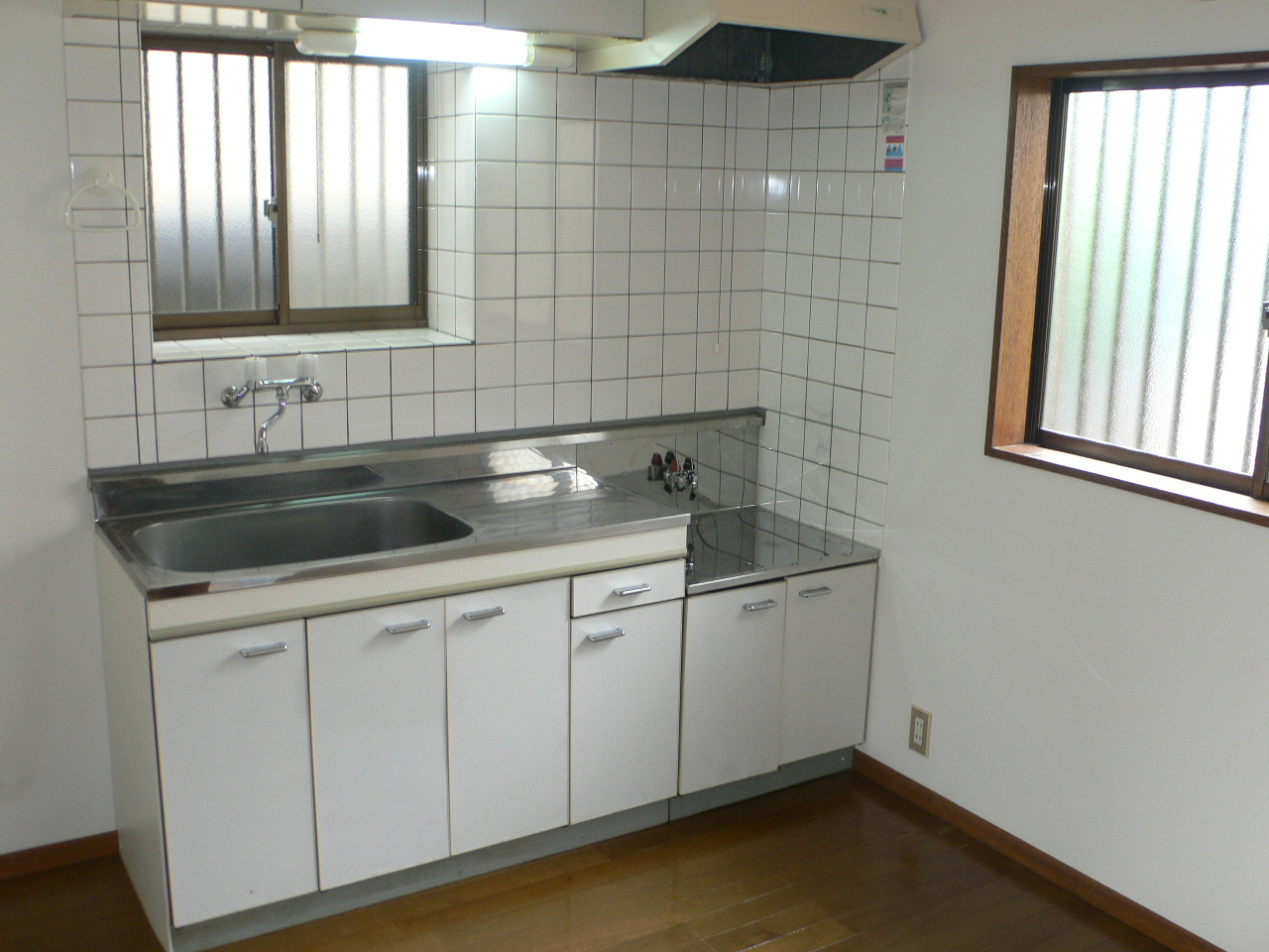 Kitchen. There is a window is bright kitchen.