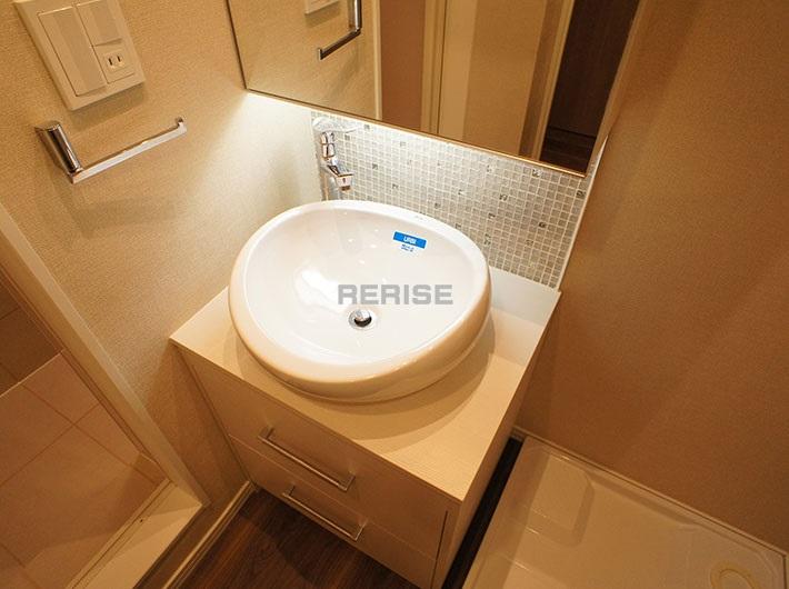 Wash basin, toilet. It is a stylish bathroom vanity