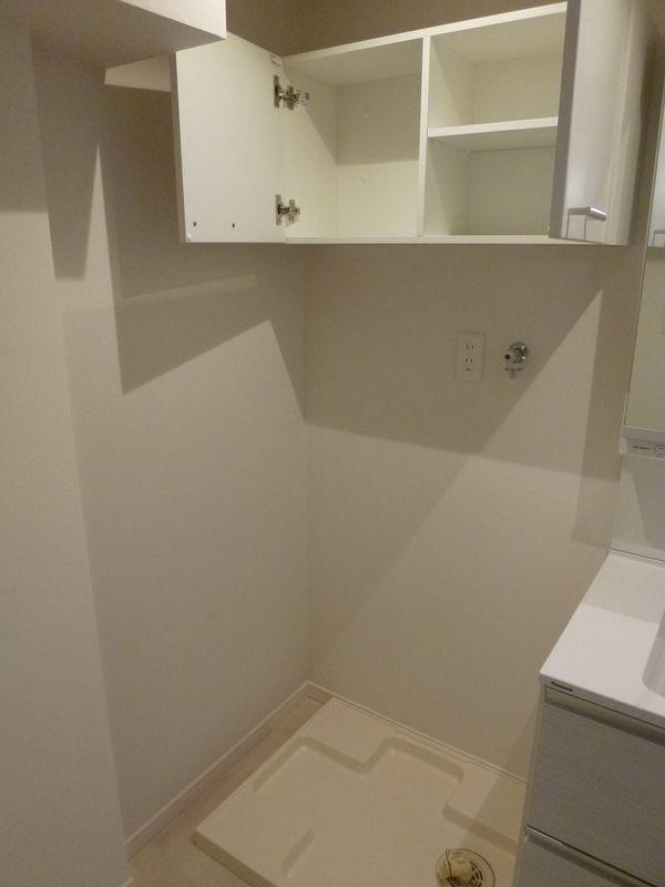 Wash basin, toilet. Indoor laundry Area