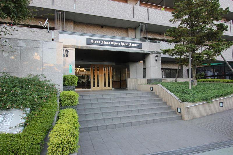 Entrance. Exterior photo of the entrance, surrounded by green