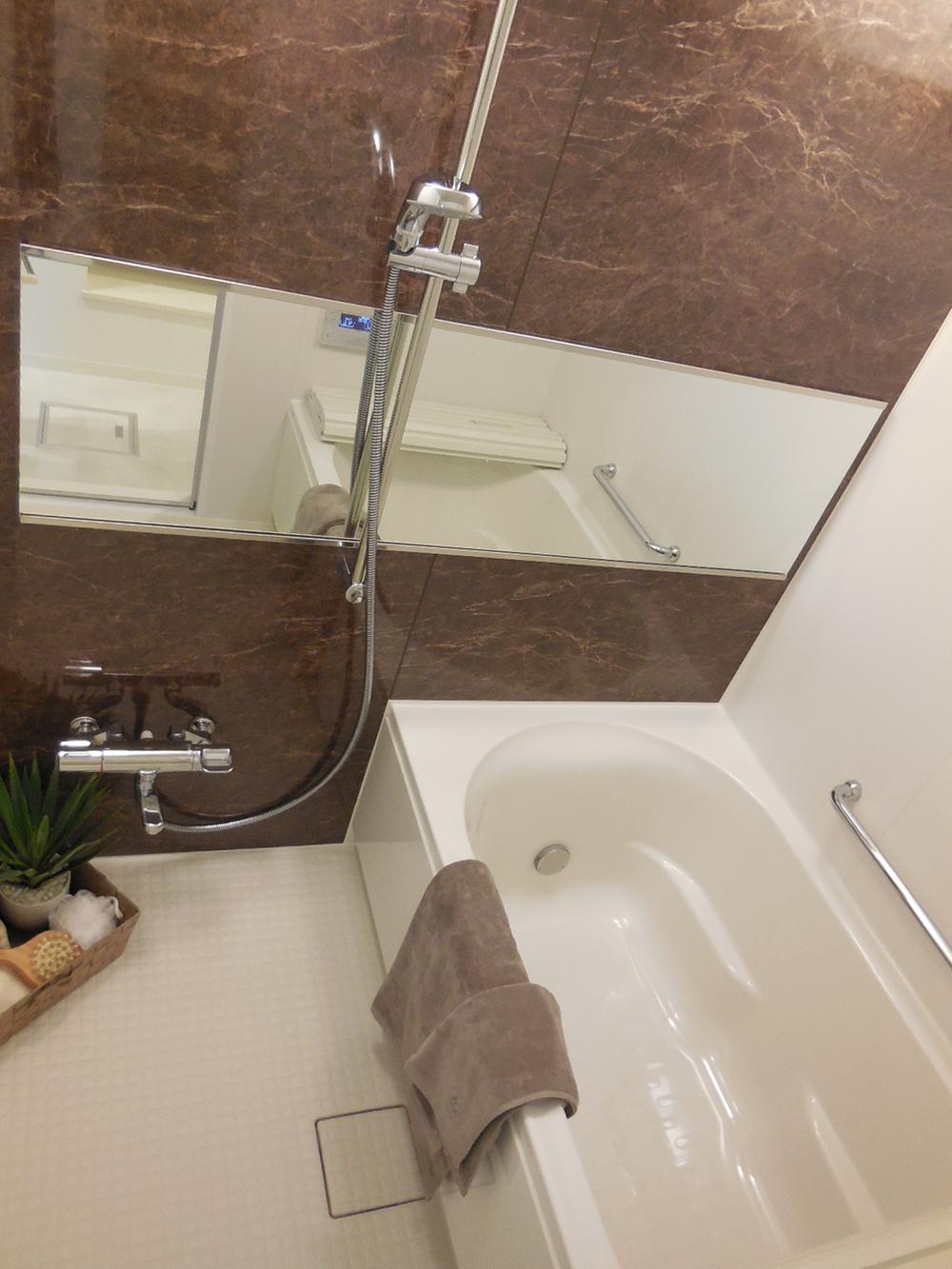 Bathroom. Long mirrors and dark wood of the panel will produce a feeling of luxury