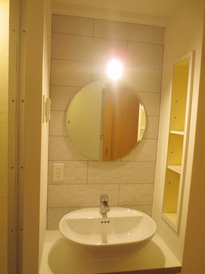 Washroom. Vanity with a round mirror