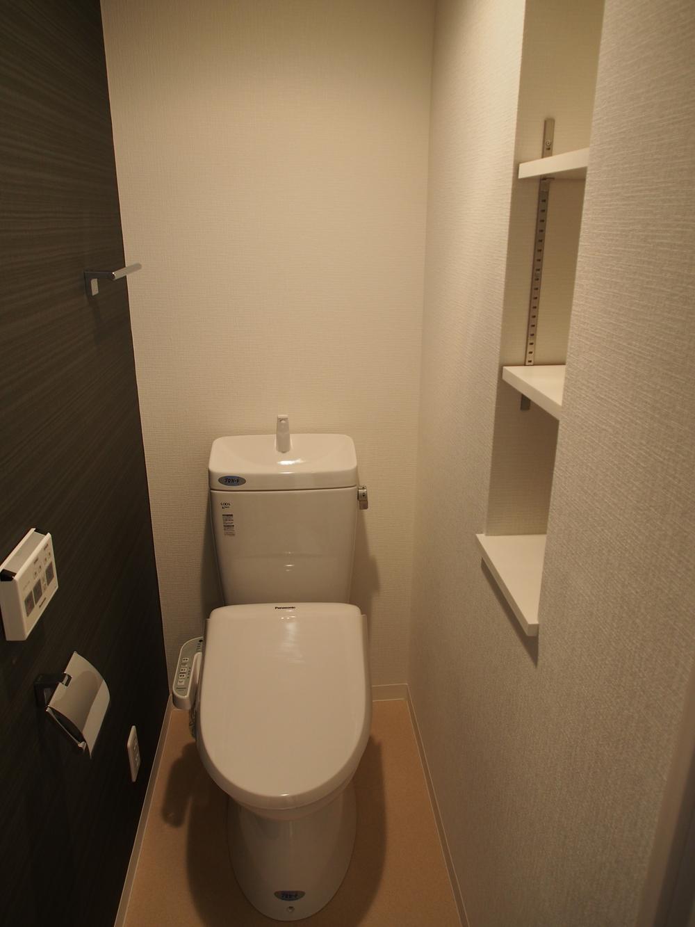 Toilet. With Panasonic warm water toilet seat. Storage room.