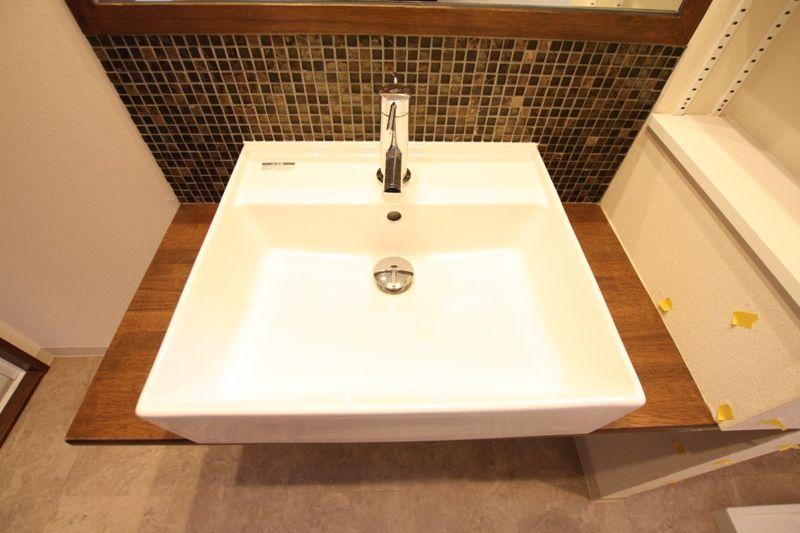 Wash basin, toilet. Wash basin was finished with mosaic tile specification