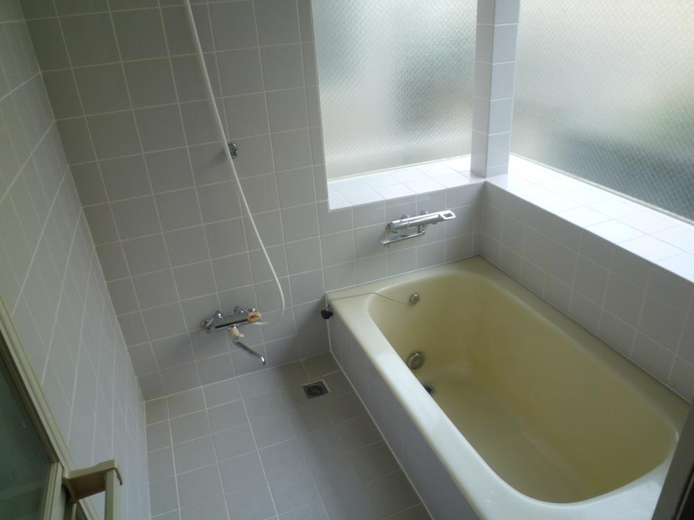 Bathroom. Corner is a bright bathroom bay window with.