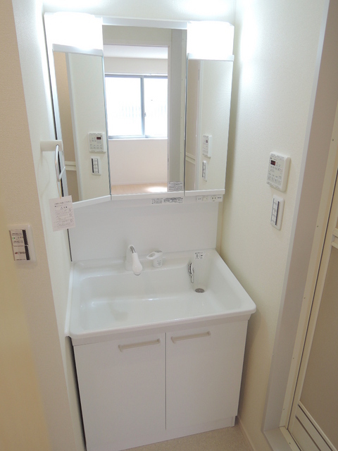 Washroom. Large wash basin of the three-sided mirror