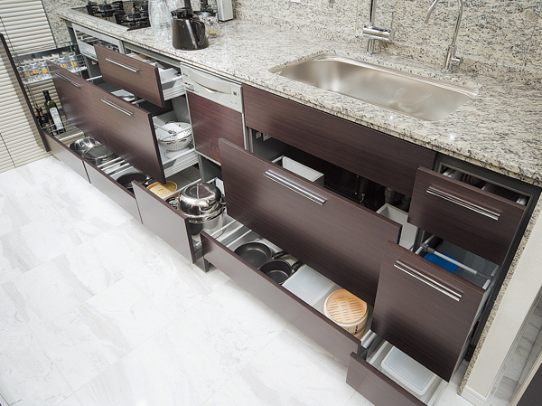 Kitchen.  [Sliding storage that can store plenty] Storage of system kitchens, It can be effectively utilized in the prone cabinet in a dead space, It has adopted a sliding storage.