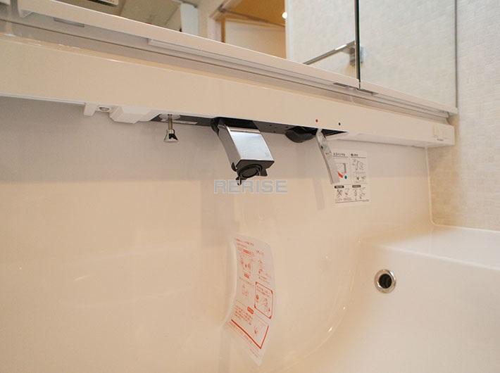 Wash basin, toilet. Basin is a vanity with a shower head