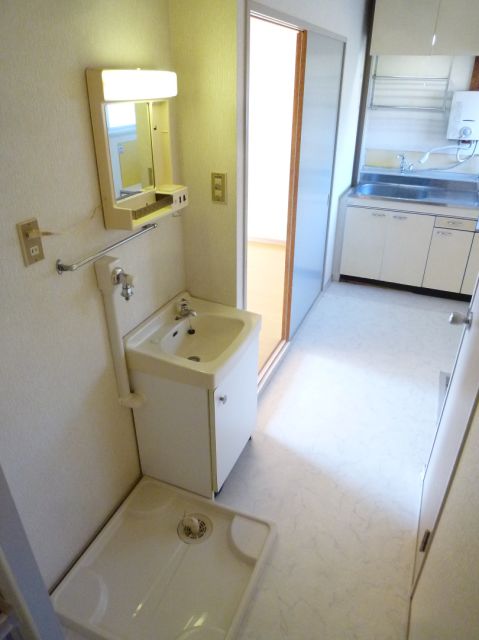 Washroom. Independent wash basin. Washing machine in the room.