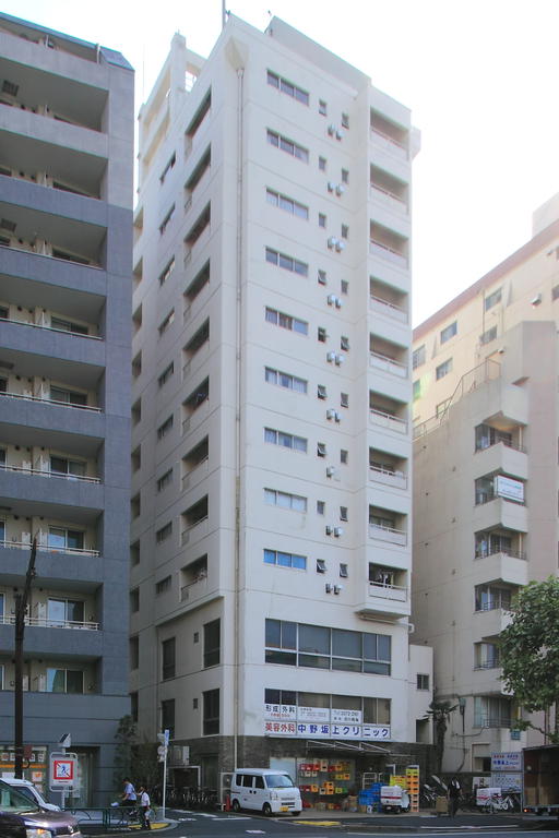 Building appearance. Sunny apartment along the street