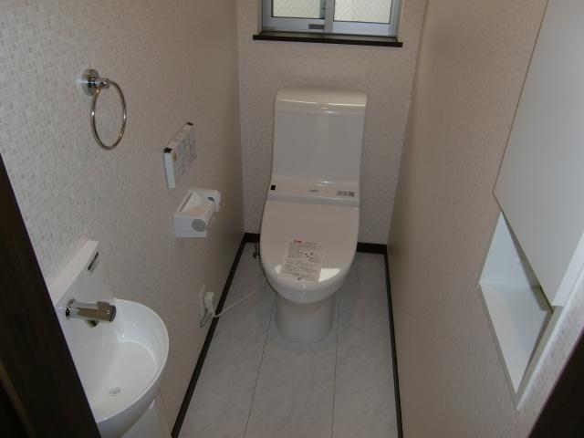 Toilet. It marked with a wall remote control and the bidet. Apart from the hand-washing type, There is also a niche storage. 