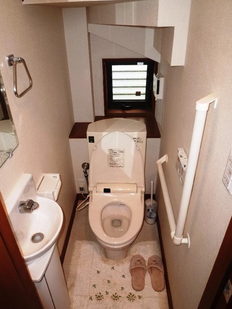 Toilet. Toilet under the first floor stairs.