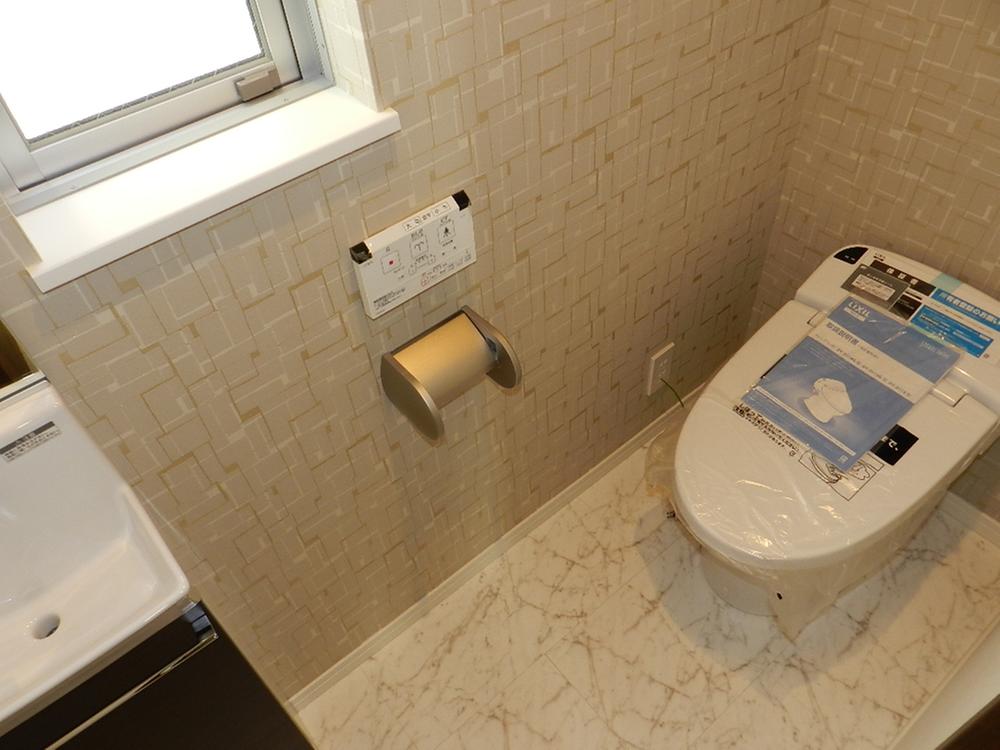 Toilet. Low silhouette toilet seat. With hand washing cabinet