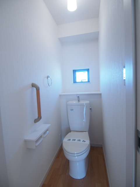 Toilet. Bright restroom with a small window!