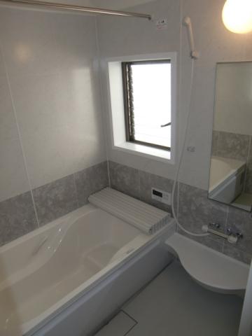 Bathroom. It is with a bathroom dryer. The window is a bright big. Also using the stylish panel wall.