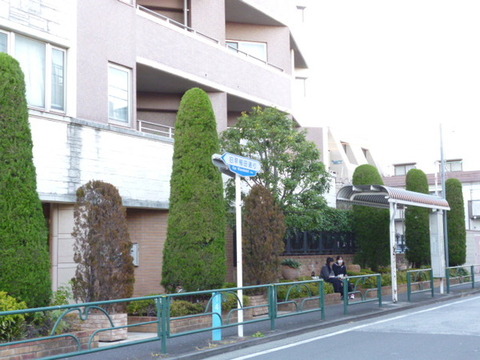 Building appearance. There is a bus stop next to the building.