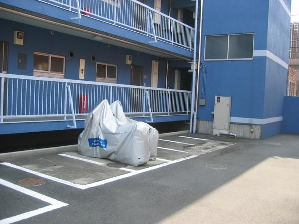 Parking lot. There is parking and bike shelter