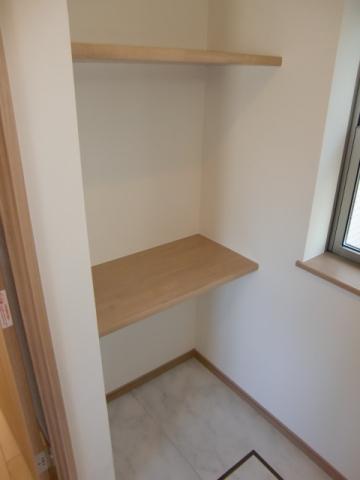 Wash basin, toilet. The washroom, It comes with shelves that come in handy to or put a towel.