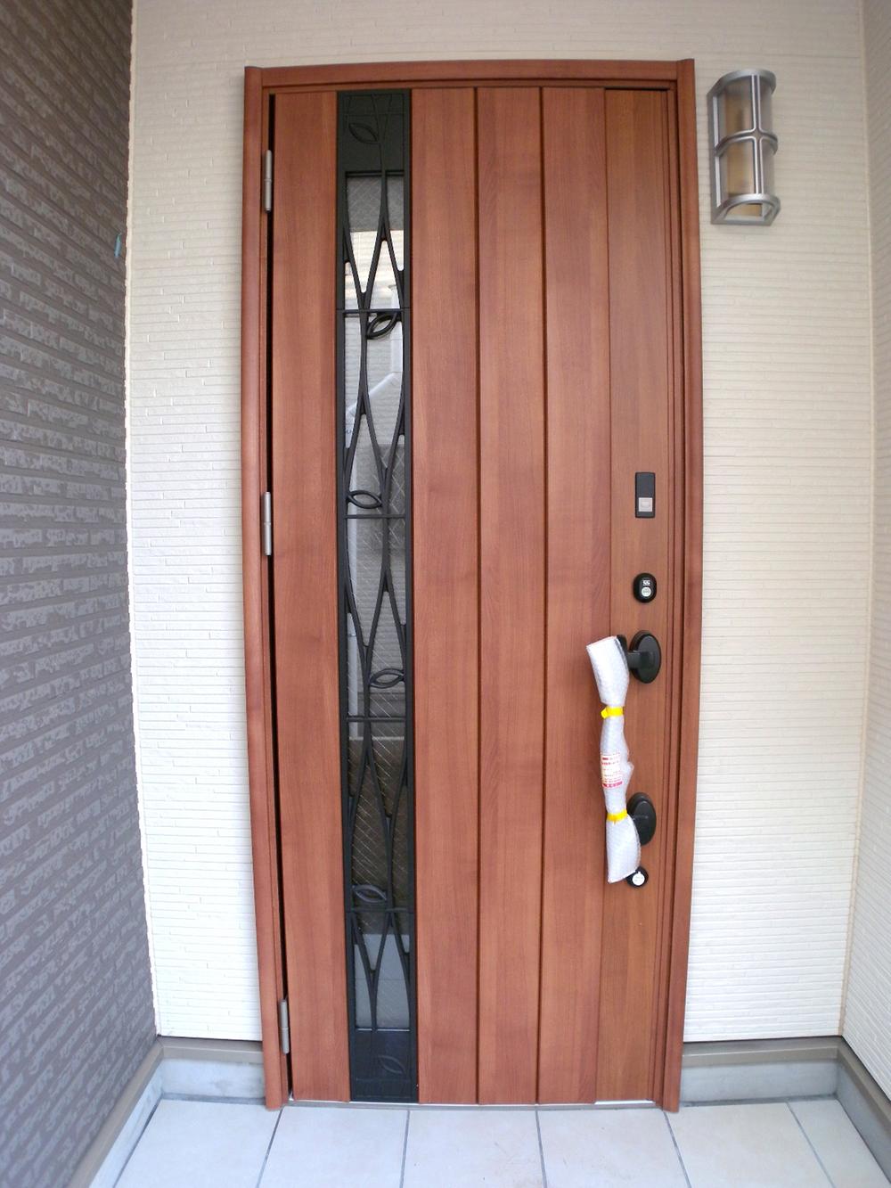 Entrance. Stylish wood grain type of entrance door [8 Building]