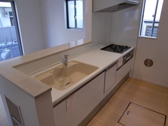 Kitchen. It is an open kitchen with a dishwasher. Artificial marble top and sink is fashionable.