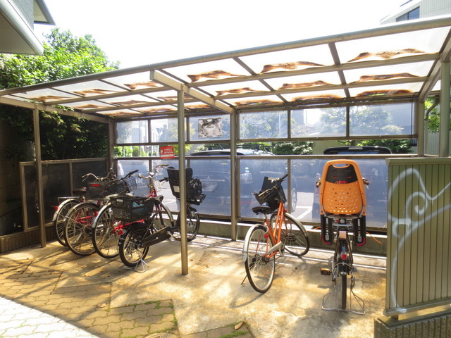 Entrance. Covered bicycle shed