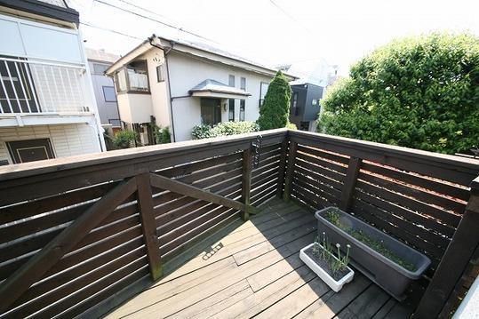 Balcony. Sunny wide wood deck