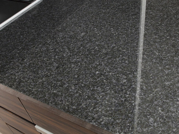 Kitchen.  [Counter tops of natural stone] Has adopted a natural stone counter that feeling of luxury.