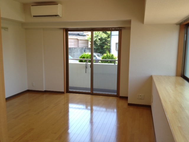 Living and room. Living (from the kitchen). Large bay windows on the right hand side. 