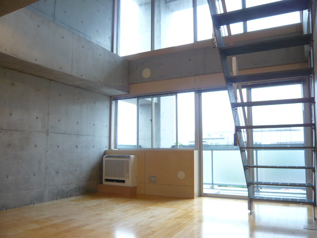 Living and room. There is a ceiling is high and airy