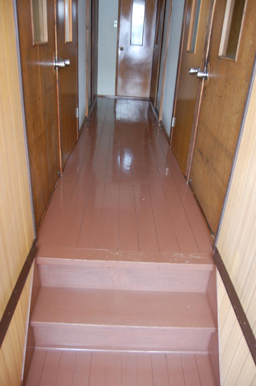 Toilet. Shared toilet is located in the back of the hallway.