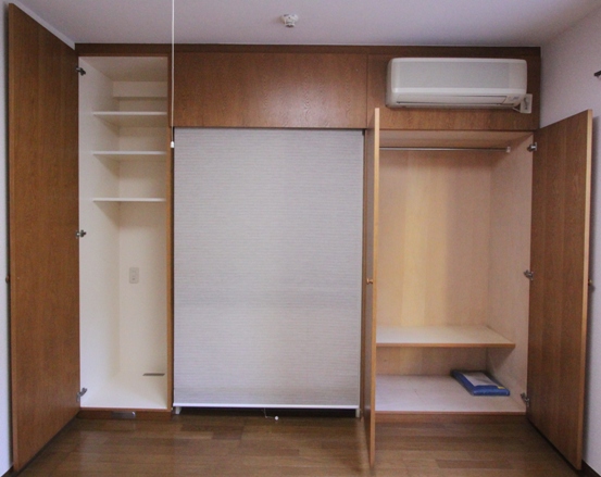 Living and room. Kitchen is hidden by the roll curtain.