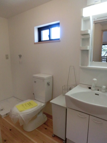Washroom. Vanity room with a window. Indoor Laundry Storage