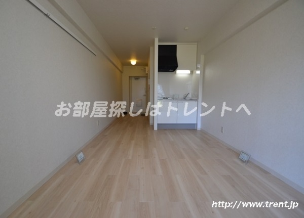 Living and room. It is a photograph of the same building by Room No.. Please see for reference.