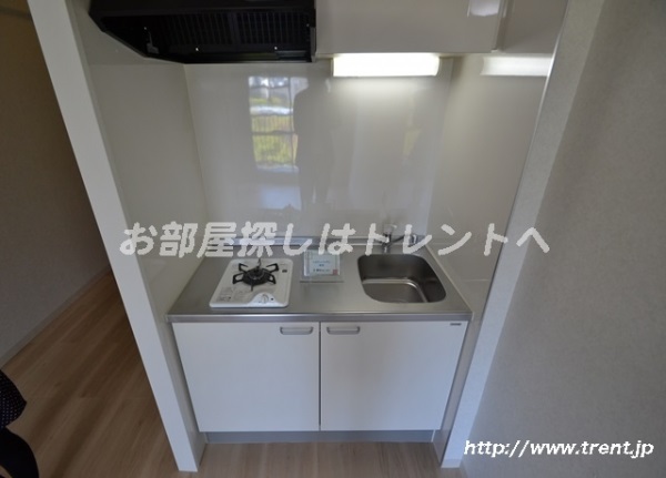 Kitchen. It is a photograph of the same building by Room No.. Please see for reference.