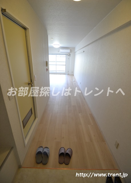 Entrance. It is a photograph of the same building by Room No.. Please see for reference.