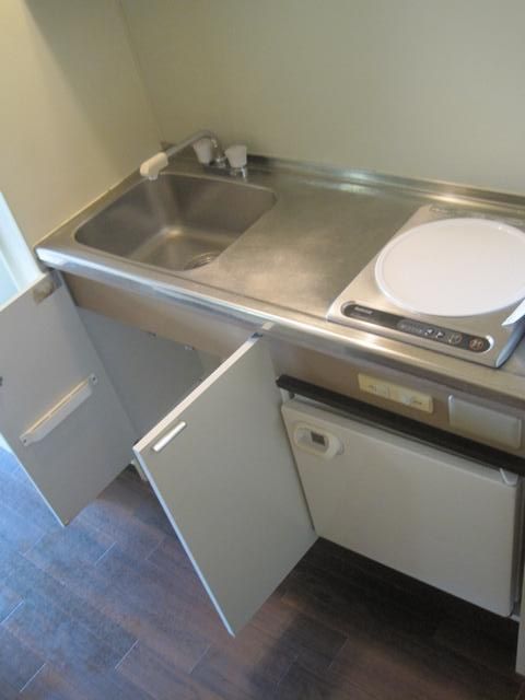 Kitchen. IH stove, With a small refrigerator.