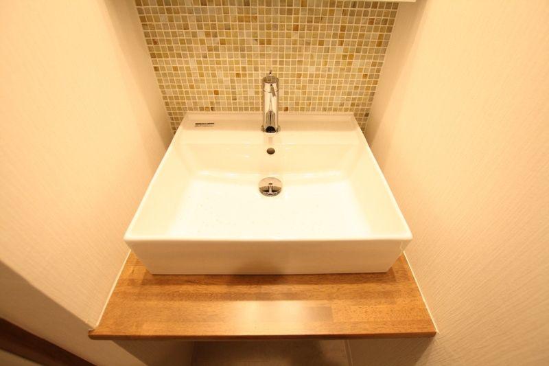 Wash basin, toilet. Wash basin was finished with mosaic tile specification