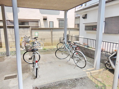 Entrance. Covered bicycle shed