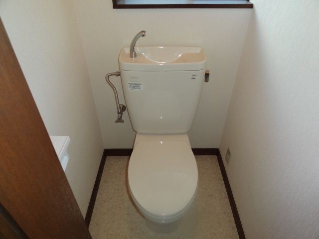 Toilet. Small window with a Western-style toilet