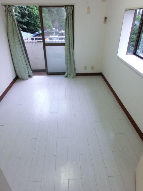 Living and room. It is a white wooden floor of the room with a clean