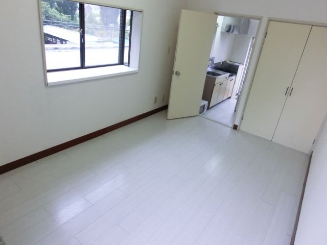 Living and room. It is a white wooden floor of the room with a clean