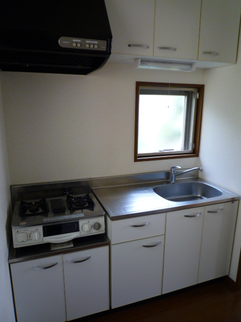 Kitchen. Window is two places in a box type of kitchen, 2 mouth is with a gas range.