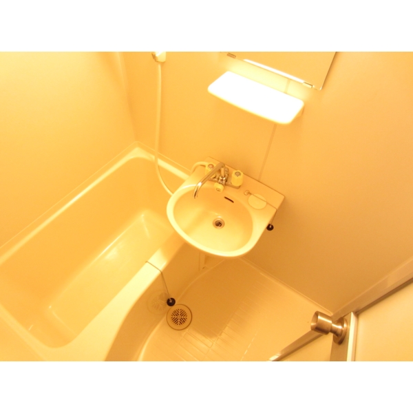 Bath. It is a bathroom with a wash bowl. mirror, It is very convenient with a shelf. 