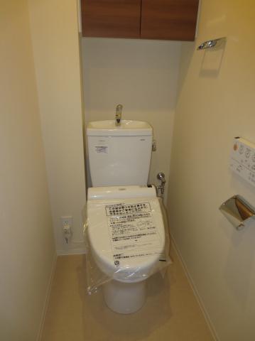 Toilet. Toilet, It is with a cleaning function. Also it comes with a storage rack.