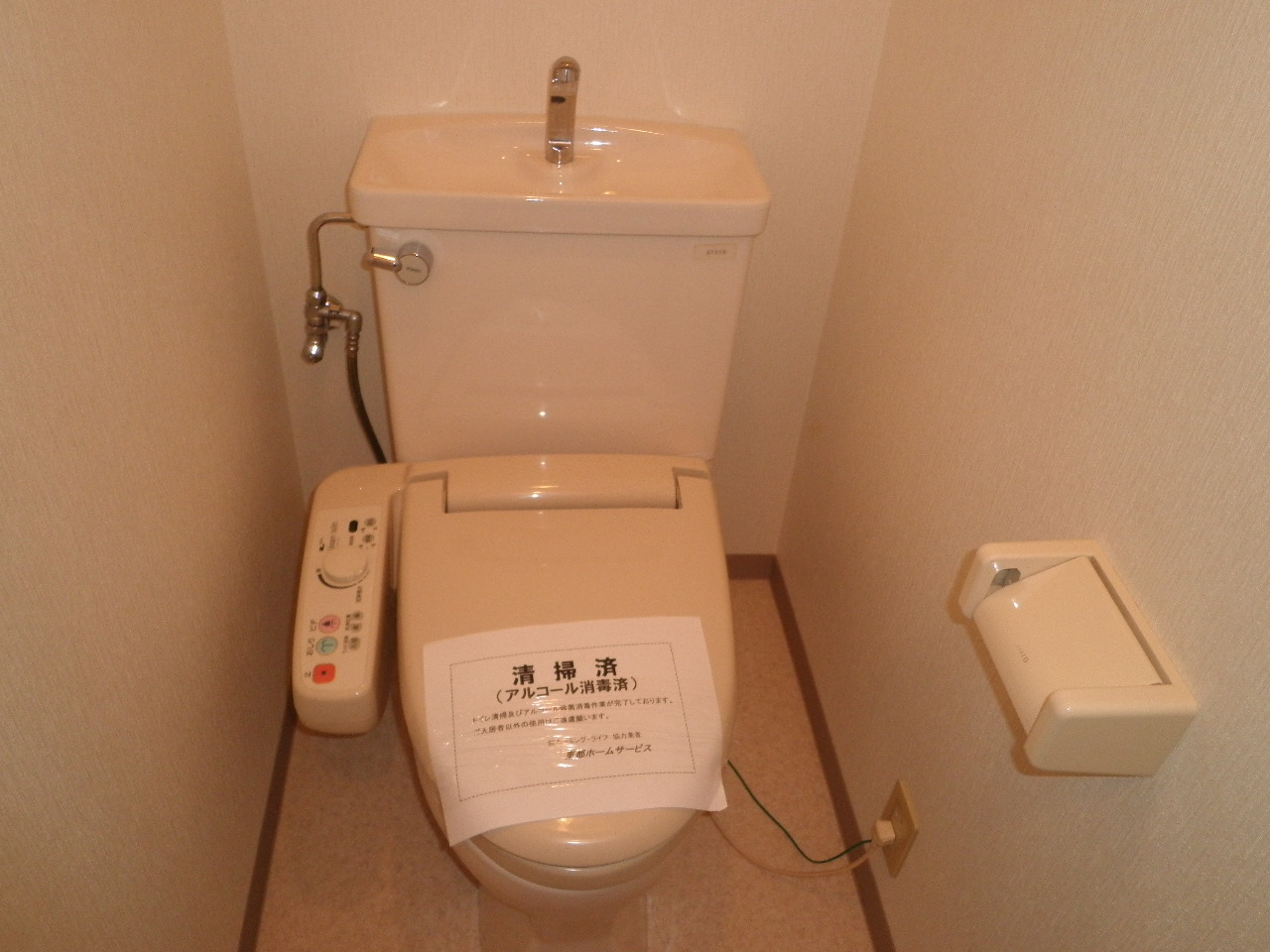 Toilet. Toilet is with a bidet. There is also storage shelf at the top